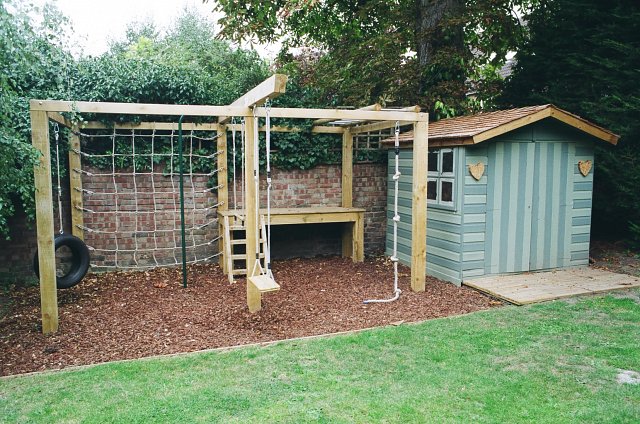 Children's playframe with playhouse with cedar shingle roof